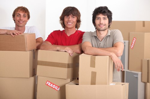 Family organizing boxes in a secure storage unit in Welling